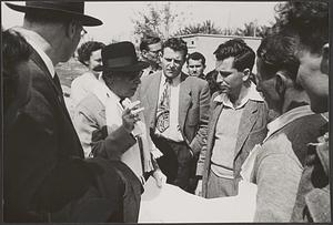 Serge Koussevitzky speaking with a group of unidentified men