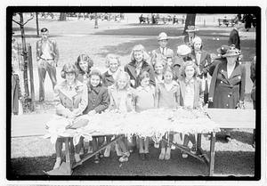 A group of girls behind a collection of sewn items