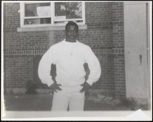 Young man posing with hands on hips