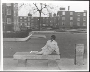 Young woman posing on a bench