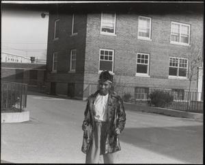 Young woman in a fur coat outside Newtowne Court