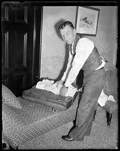 A man packing a suitcase