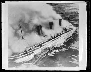 French liner SS Atlantique on fire off Guernsey, England