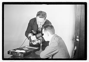 A man being shown images through an optical device