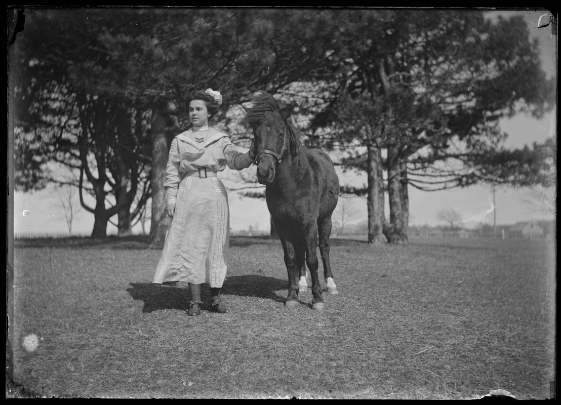 Young lady with saddle horse