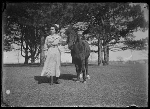Young lady with saddle horse