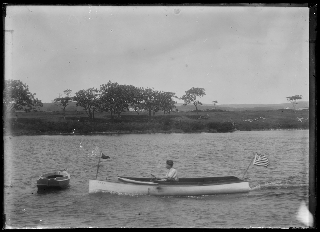 Powerboat w/ dory on pond. Another boat end-on