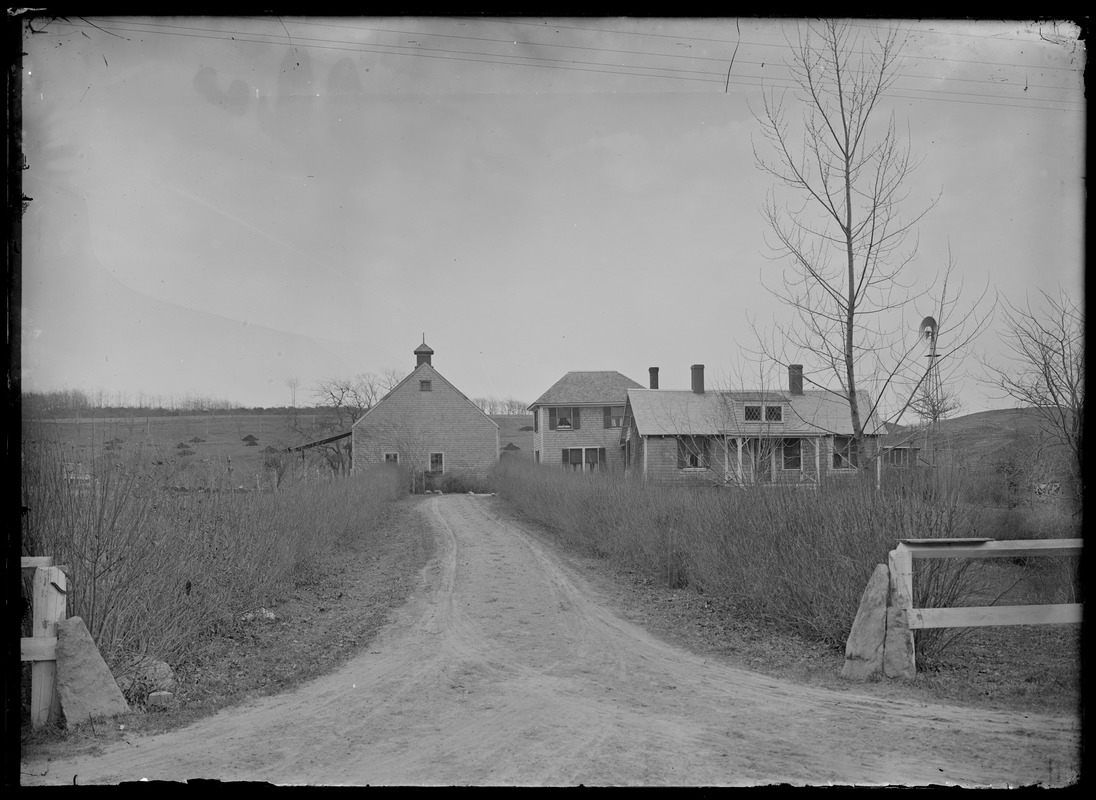 2 houses, barn, driveway, windmill. Taken near street