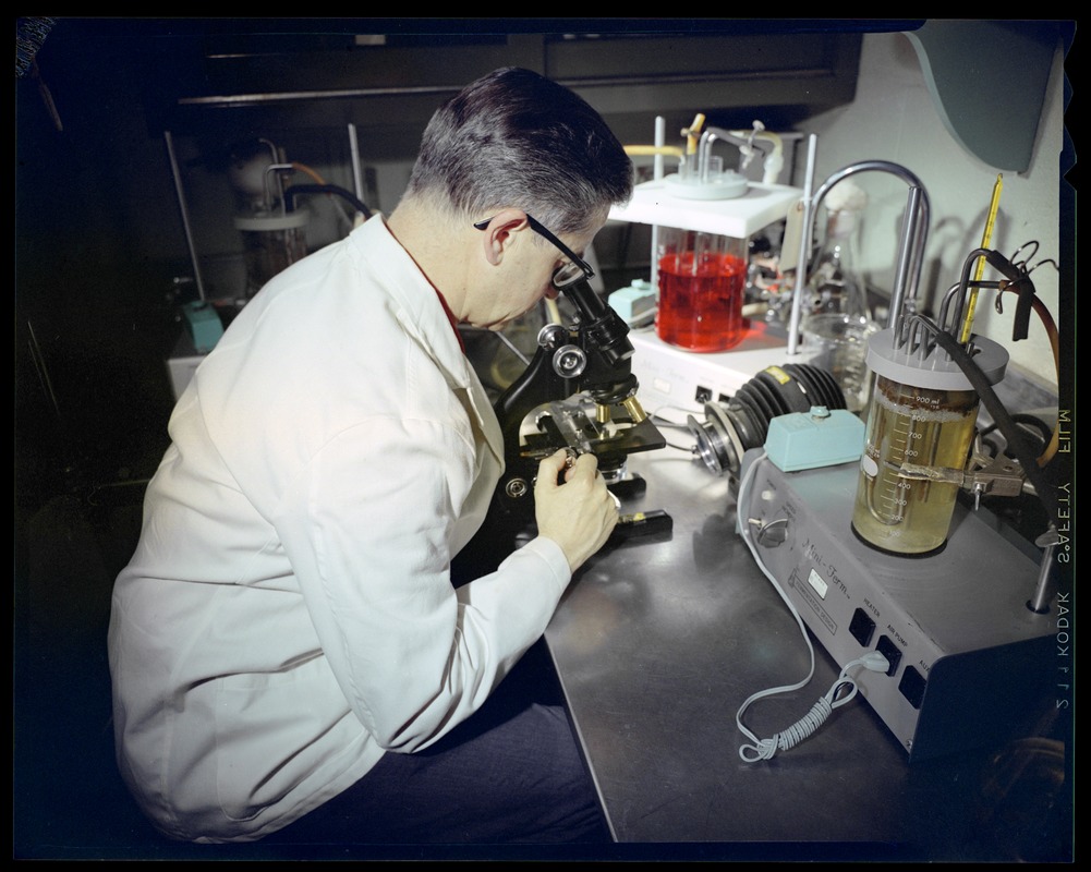 Personnel, microbiologist Morris Rogers w/microscope