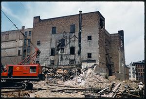 Construction equipment and rubble in front of partly demolished building, Boston