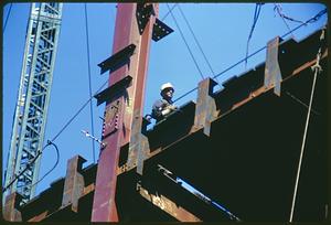 Construction worker on steel frame of building, Boston