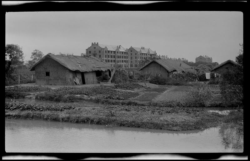 Rustic buildings in foreground, brick buildings in background