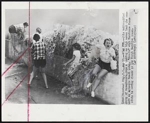 What Fun -- This unidentified group of vacationers, hets a ducking as high waves lash the seawall at Atlantic Beach today. 'Connie' with Hurricane force winds is moving closer to the North Carolina coast.