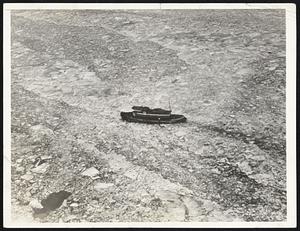 Cold Wave Chokes Hudson River With Ice. A cold wave which sent the mercury tumbling down to 19 degrees Jan. 13, caused the Hudson river to choke up with ice near Kingston, N. Y. This photo shows a sturdy little tug pushing a way through the floating fields of ice, while the photographer rides high overhead in a plane.