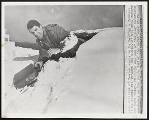 Plymouth, Mass. -- Four Wheeled Foxhole -- John Phillips of Boston seems to be leaving a foxhole as he climbs out through the window of his snow-covered car here today. Phillips was one of the many motorists snowbound on the roads during the worst snow storm in fifty years on Cape Cod.