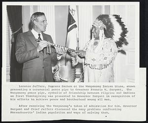 Lorenzo Jeffers, Supreme Sachem of The Wampanoag Indian Tribe, shown presenting a ceremonial peace pipe to Governor Francis W. Sargent. The Wampanoag peace pipe, symbolic of friendship between Pilgrims and Indians on first Thanksgiving was presented to Governor Sargent in recognition of his efforts to achieve peace and brotherhood among all men. After receiving The Wampanoag's token of admiration for him, Governor Sargent and Chief Jeffers discussed the many problems confronting Massachusetts' Indian population and ways of solving them.