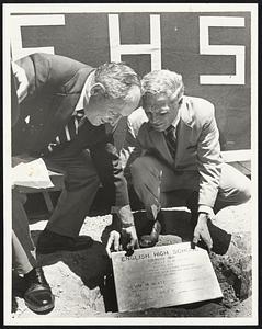 Mayor Kevin White and Bill Stewart, president of Boston English High School's alumni association, bury time capsule containing one of hockey star Bobby Orr's sweat shirts and TV dinner during yesterday's ground-breaking ceremonies for the new school. The capsule also contains some serious mementos of 1970 and will be opened in the year 2120.