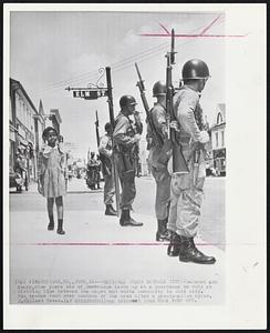 Cambridge, Md. – National Guard Patrols City – Deborah Ann Sharp, nine years old of Cambridge looks up at a guardsman on duty at dividing line between the negro and white community in this city. The troops took over control of the area after a proclamation by Gov. J. Millard Tawes.