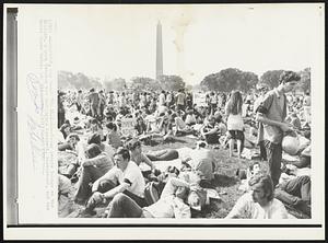 On the Ellipse-- Young people lounge on the ellipse, a park between the Washington Monument, background, and the White House today.