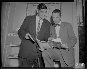 Two men looking at magazine