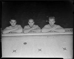 Three swimmers at the side of McCurdy Natatorium