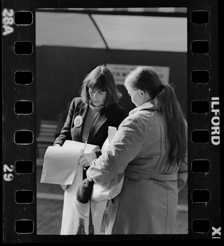 Market researcher interviews customers at shopping mall in Brighton