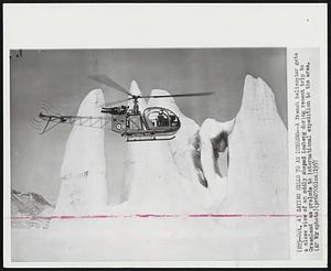 Saying Hello To An Iceberg--A French helicopter gets a close view of an oddly shaped iceberg during recent trip to Greenland as prelude to international expedition to the area.