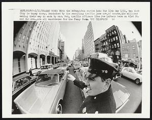 With the subway-bus strike into it 11th day 1/11, New York City is topsy turvy. Headached by the resulting traffic jams are, of course, the millions making their way to work by car. But, traffic officers like Joe LoPreto here on 43rd St. and 2nd Ave., are all candidates for the funny farm.