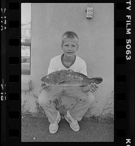 Boy holding fish