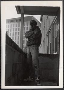 Teen with a baseball cap and standing in a still pose