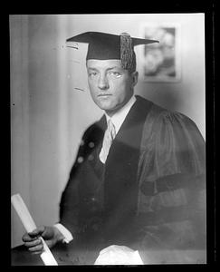 An unidentified man wearing a cap and gown