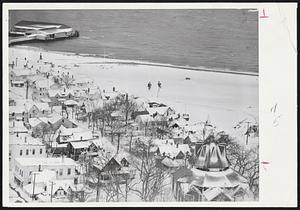 Oak Bluffs Now Snow Bluffs -- Oak Bluffs on Martha’s Vineyard island doesn’t look a bit like the popular summer resort known to thousands of vacationists. This photo made yester shows snowbound cottages, steamer wharf (upper left) and a relic of camp meeting days (lower right). The Vineyard and Nantucket received their first mail and supplies from mainland yesterday after the two big blizzards.