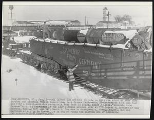 Huge German Gun Arrives in U.S.--Here for study by army arms experts and eventual public exhibition, this German Krupp-made 28-centimeter K5-E gun that can fire a rocket-assisted projectile more than 50 miles, bears a label, "souvenir from Germany" as it is inspected at the army proving grounds here by T/5 George H. Barrett of New Bedford, Mass., (top) and Sgt. David B. Dreiman of Minneapolis, Minn., (below). Gun was captured by allies in Europe. It is one of three big weapons now at Aberdeen.