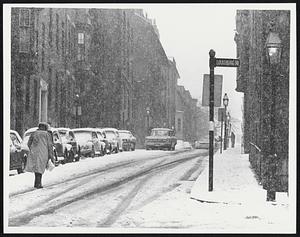 A lady makes her way up Beacon Hill near Louisburg Sq.