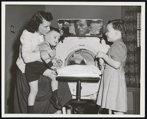 March of Dimes Campaign aids patients such as Thomas Smith of Brighton, in iron lung, being visited at the Mary McArthur Memorial Center in Wellesley by his wife and two children, Michael, 3 1/2, and Maureen, 5.