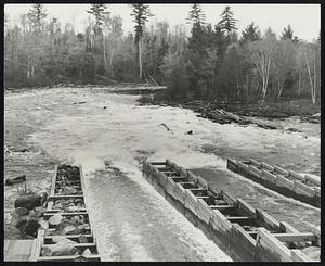 Logs on the Move - For the first time in 30 years a drive of 12-foot-high white pine logs was released into the Rapid river, Maine, to float down to the plants of Brown Co., pulp and paper products, at Berlin, N.H. Right-hand picture shows the beginning of the drive. The logs are moving into the dam, which is under the wooden building in the picture. The lower left hand photo shows the logs racing down the sluiceways into the Rapid river. At upper left, Laurence F. Whittemore (in checked shirt), president of Brown Co., inspects the start of the drive from a raft.