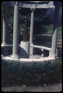 A gazebo with a sculpture of a woman in the center