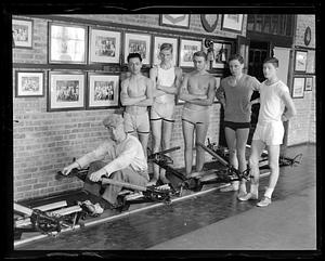 Coach Bert Haines showing freshmen how the new single rowing machines worked at the Weld Boat House at Harvard, Feb. 16, 1932