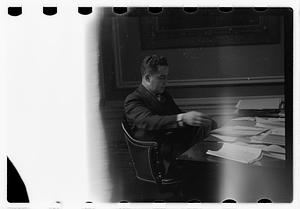 A man seated at a desk