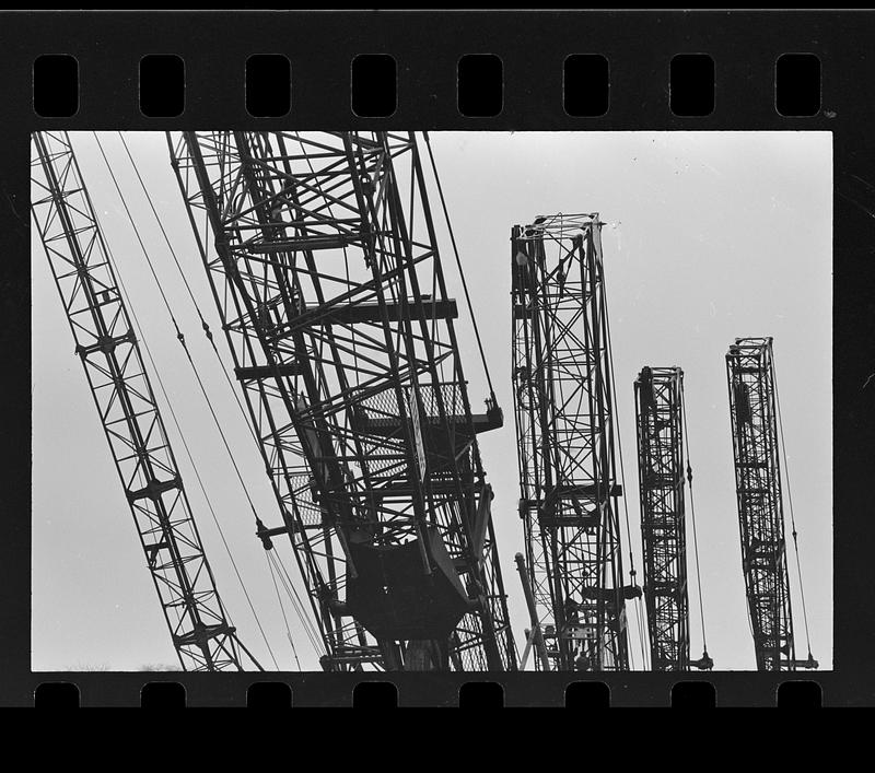 Folded construction cranes in storage yard, Everett