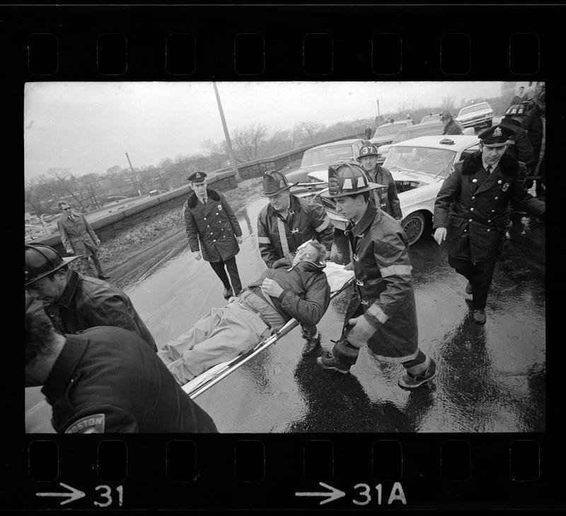 Firemen carry Jamaicaway auto crash victim, Boston