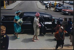 People in formal dress getting out of car by sidewalk, Jamaica Plain, Massachusetts
