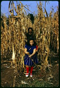 Woman and girl standing in cornfield