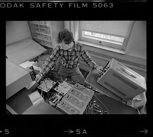 Man adjusts electronic equipment