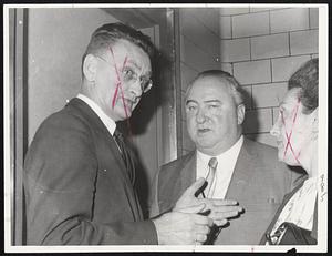 It's Official- Dr. Charles Averill, left, executive officer at City Hospital, explains details of injury suffered by Cassius Clay to Boston fight promoter Sam Silverman. Clay's entry into hospital forced cancellation of Monday night's fight.