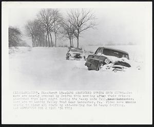 Lancaster, Pa -- Cars Abandoned During Snow Storm -- Two cars are nearly coved by drifts this morning after their drivers abandoned them last night during the heavy snow fall. Cars are on Landis Valley Road near Lancaster, Pa. Plows were unable to clear all roads by mid-morning due to heavy drifting.