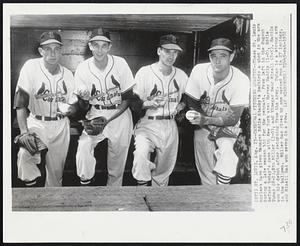 Cardinal Pitching Quartet--These St. Louis hurlers have given Manager Eddie Stanky's Redbirds a shot in the arm during a late season bid for the pennant. From left in the dugout before today's game with New York are: Harvey Haddix (1-0), Eddie Yuhas (8-2), Stu Miller (3-0), and Vinegar bend Mizell (8-5). Haddix won his debut after returning from the Army. Yuhas is a strong arm in the bullpen. Miller has given up one earned run in 27 innings, and Mizell has won seven in a row.