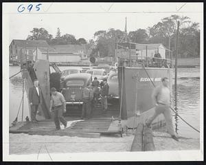 Vacationists' Automobiles Back on Mainland--The Susanna Marie, a former Navy LCT, operated by two war veterans, docks in the Wareham river at Wareham with a cargo of 30 automobiles and a truck load of cranberries from Nantucket. Cars had been held up on the is'and by strike of crews of Massachusetts Steamship Lines.