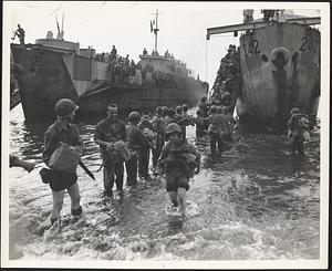 American Army nurse wades ashore at Naples from an LCI