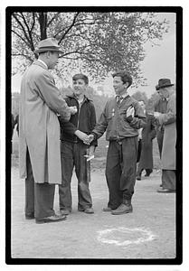 Two boys, both wearing medals, shaking hands
